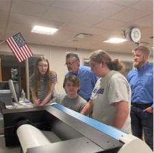 Student Group with Mark Glendenning, CEO of Inland Packaging, working with donated printer