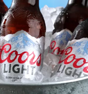 Coors Light beers featuring color-changing cut-and-stack label in a bucket with ice.