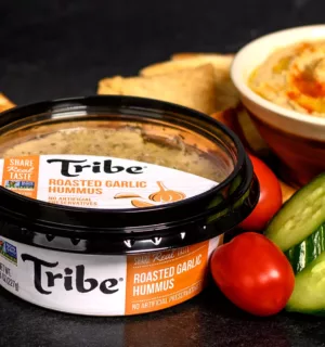 Tribe Roasted Garlic Hummus in pressure-sensitive product packaging.