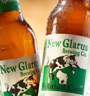 New Glarus Spotted Cow beer with cut-and-stack bottle label.