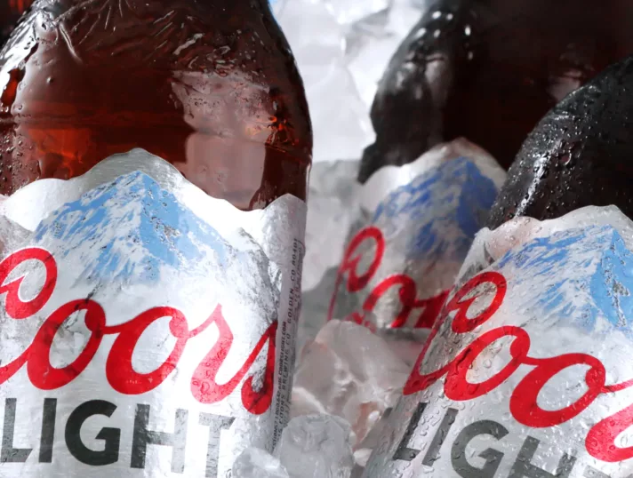 Coors Light beers featuring color-changing cut-and-stack label in a bucket with ice.