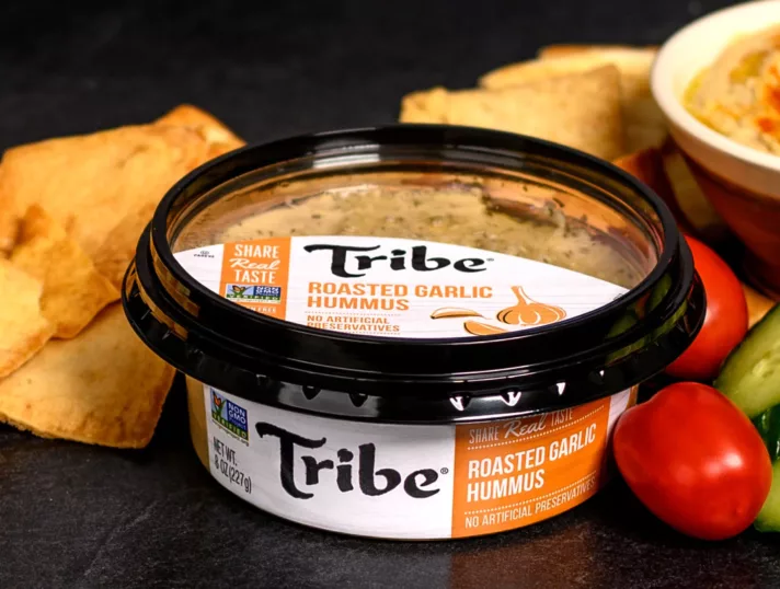 Tribe Roasted Garlic Hummus in pressure-sensitive product packaging.